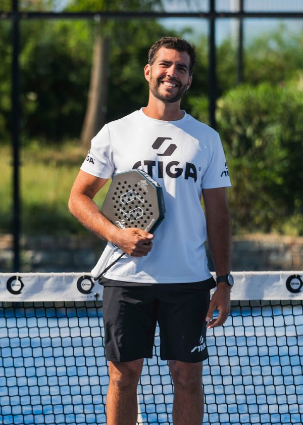 Xavier Aparicio holding a padel racket at the net